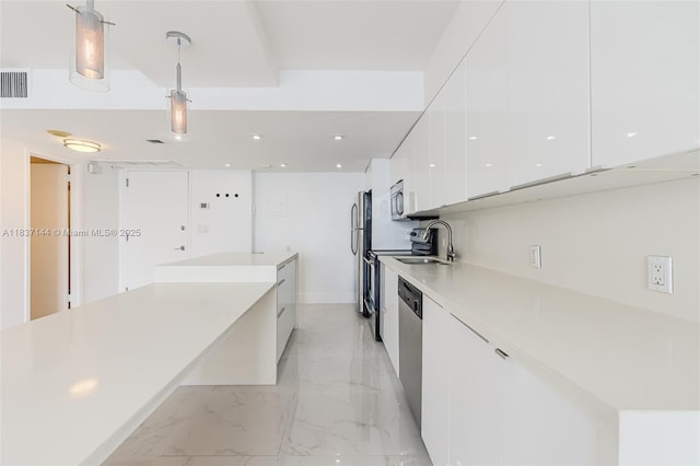 5701 Collins Ave Unit 1611, Miami Beach, FL 33140 - kitchen with modern cabinets, white cabinets, stainless steel appliances, light marble finish floors, and light countertops