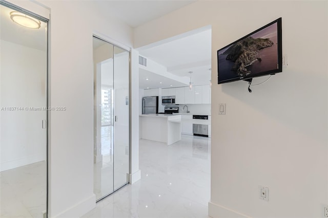 5701 Collins Ave Unit 1611, Miami Beach, FL 33140 - hallway featuring light marble finish floors and baseboards
