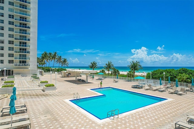 5701 Collins Ave Unit 1611, Miami Beach, FL 33140 - community pool featuring a water view and a patio