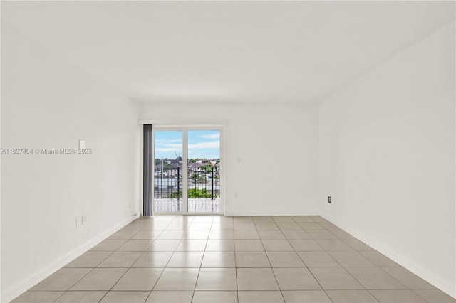 1990 W 56th St Unit 1407, Hialeah, FL 33012 - spare room with light tile patterned floors and baseboards