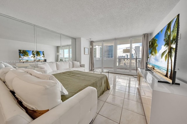 1717 N Bayshore Dr Unit A-3237, Miami, FL 33132 - bedroom featuring access to outside, a textured ceiling, light tile patterned flooring, and expansive windows