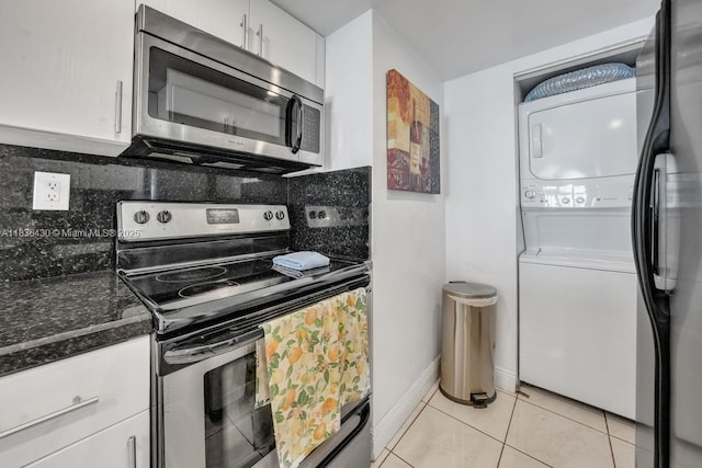 1717 N Bayshore Dr Unit A-3237, Miami, FL 33132 - kitchen featuring stainless steel appliances, stacked washer and clothes dryer, white cabinets, backsplash, and light tile patterned floors