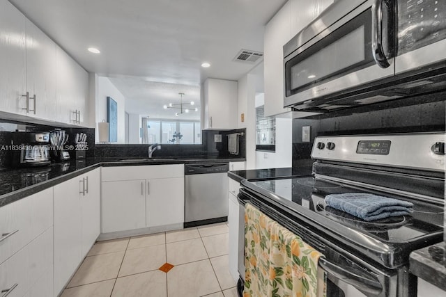 1717 N Bayshore Dr Unit A-3237, Miami, FL 33132 - kitchen featuring appliances with stainless steel finishes, tasteful backsplash, white cabinetry, light tile patterned floors, and recessed lighting