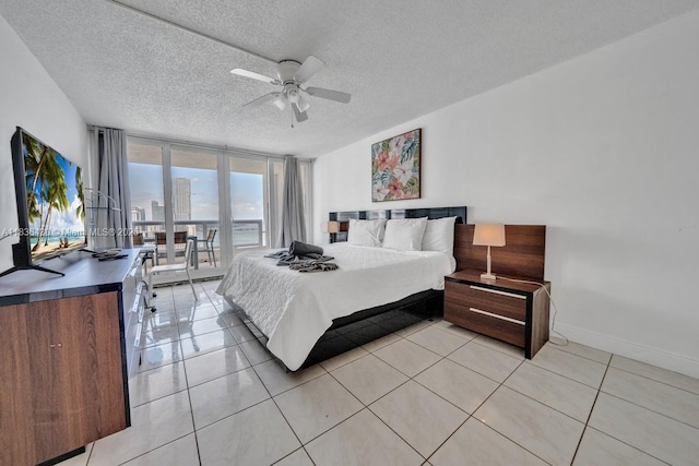 1717 N Bayshore Dr Unit A-3237, Miami, FL 33132 - bedroom with access to outside, a textured ceiling, light tile patterned flooring, a wall of windows, and a ceiling fan