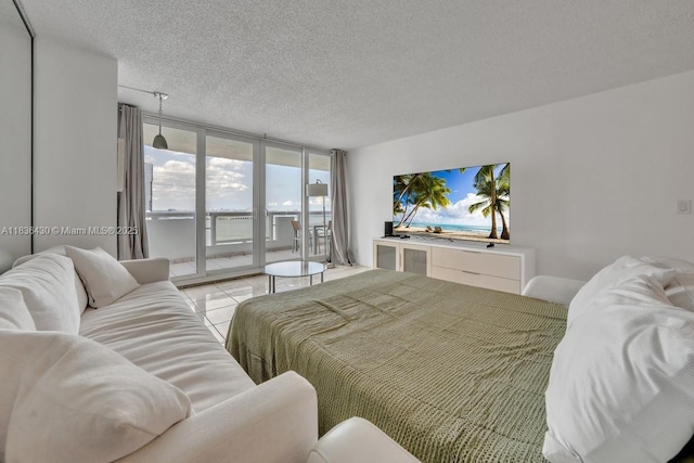 1717 N Bayshore Dr Unit A-3237, Miami, FL 33132 - bedroom featuring access to outside, a wall of windows, a textured ceiling, and tile patterned floors