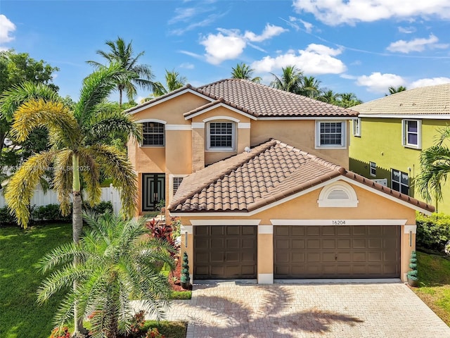 16204 SW 18th Pl, Miramar, FL 33027 - mediterranean / spanish-style home featuring stucco siding, a tile roof, decorative driveway, and an attached garage