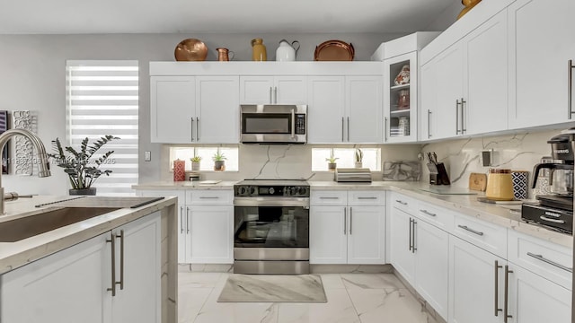 16204 SW 18th Pl, Miramar, FL 33027 - kitchen featuring stainless steel appliances, healthy amount of natural light, light marble finish floors, and white cabinetry