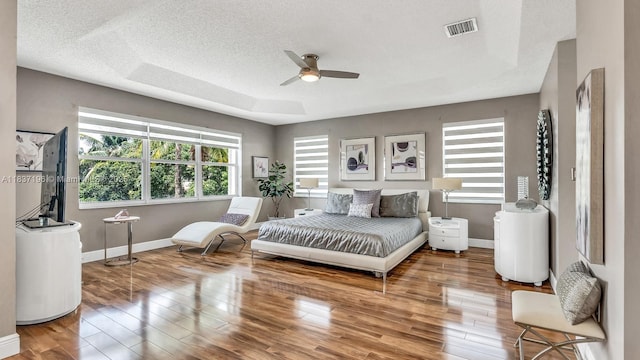 16204 SW 18th Pl, Miramar, FL 33027 - bedroom with wood finished floors, ceiling fan, and a tray ceiling
