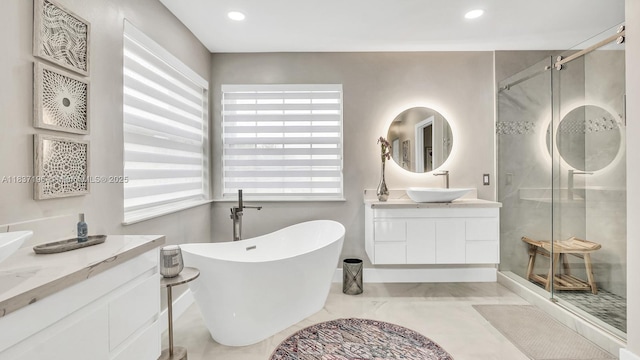 16204 SW 18th Pl, Miramar, FL 33027 - bathroom with two vanities, a shower stall, a freestanding tub, and recessed lighting