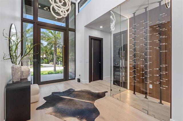 416 NW 24th St, Wilton Manors, FL 33311 - wine room with wood finished floors, a chandelier, and plenty of natural light