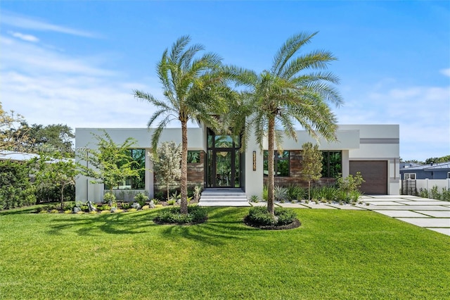 416 NW 24th St, Wilton Manors, FL 33311 - contemporary house featuring a garage, stucco siding, concrete driveway, and a front lawn