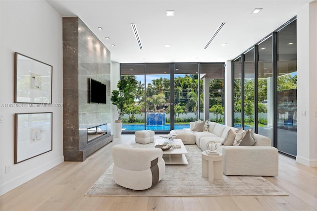 416 NW 24th St, Wilton Manors, FL 33311 - living room featuring a wall of windows and wood finished floors