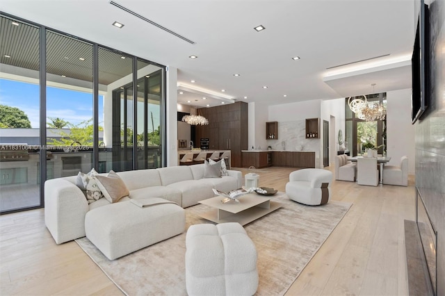 416 NW 24th St, Wilton Manors, FL 33311 - living area with a chandelier, light wood-type flooring, floor to ceiling windows, and recessed lighting