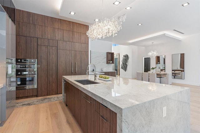 416 NW 24th St, Wilton Manors, FL 33311 - kitchen with a chandelier, modern cabinets, light wood-style flooring, and recessed lighting