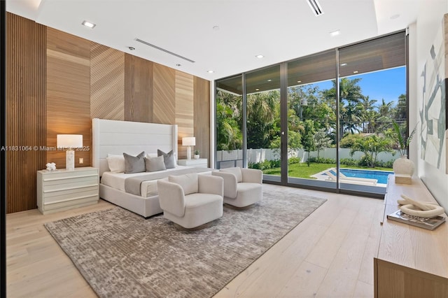 416 NW 24th St, Wilton Manors, FL 33311 - bedroom featuring a wall of windows, access to outside, light wood-style flooring, wood walls, and recessed lighting