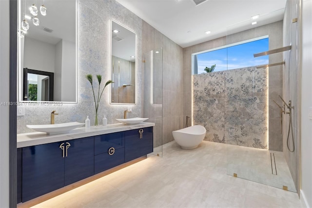 416 NW 24th St, Wilton Manors, FL 33311 - bathroom with a walk in shower, double vanity, tile walls, tile patterned flooring, and a freestanding bath