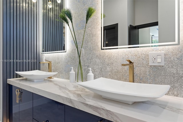 416 NW 24th St, Wilton Manors, FL 33311 - bathroom featuring double vanity and tasteful backsplash