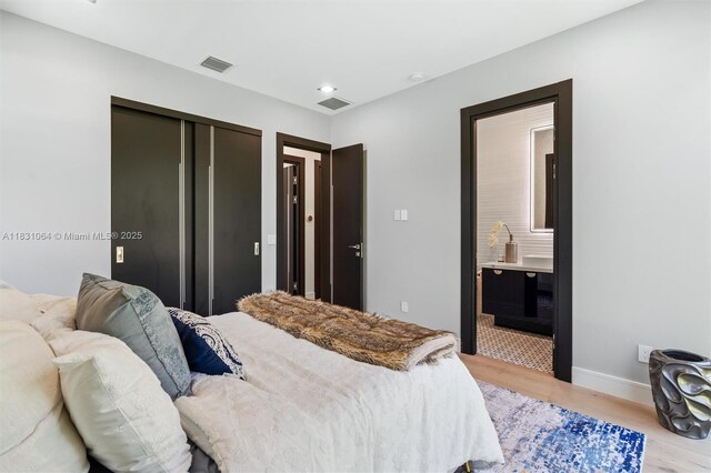 416 NW 24th St, Wilton Manors, FL 33311 - bedroom with light wood-style flooring, recessed lighting, a closet, and ensuite bath
