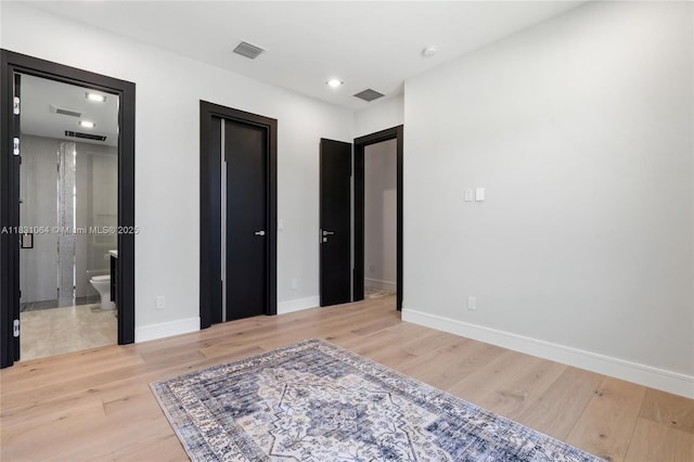 416 NW 24th St, Wilton Manors, FL 33311 - unfurnished bedroom featuring light wood-type flooring, recessed lighting, and ensuite bathroom