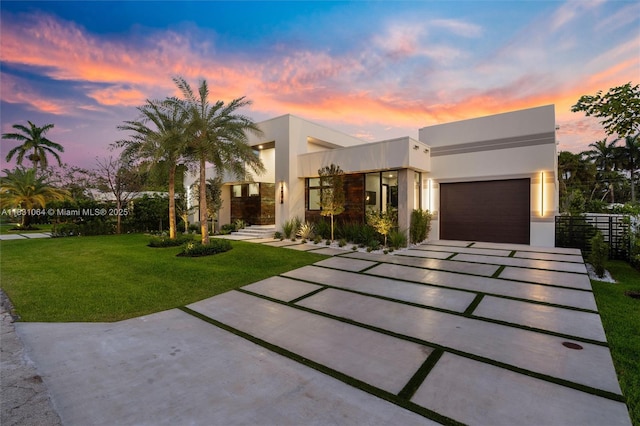 416 NW 24th St, Wilton Manors, FL 33311 - contemporary house featuring concrete driveway, stucco siding, and an attached garage