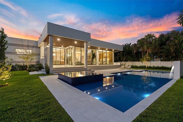 416 NW 24th St, Wilton Manors, FL 33311 - back of property at dusk featuring a patio and stucco siding