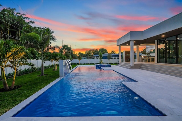 416 NW 24th St, Wilton Manors, FL 33311 - pool at dusk featuring a fenced backyard and a patio area