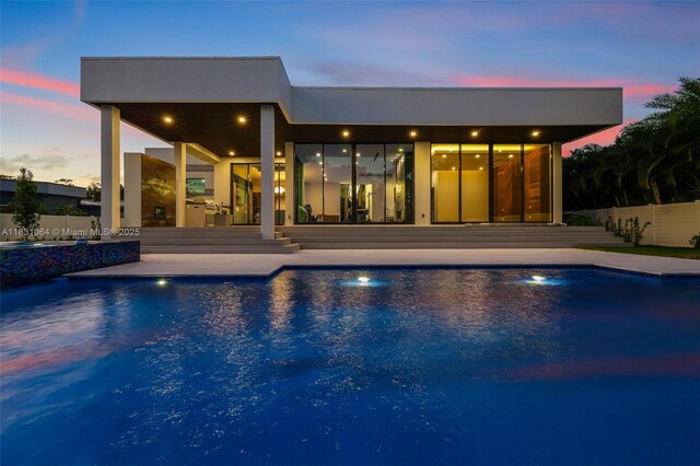 416 NW 24th St, Wilton Manors, FL 33311 - pool at dusk featuring a patio and a pool with connected hot tub