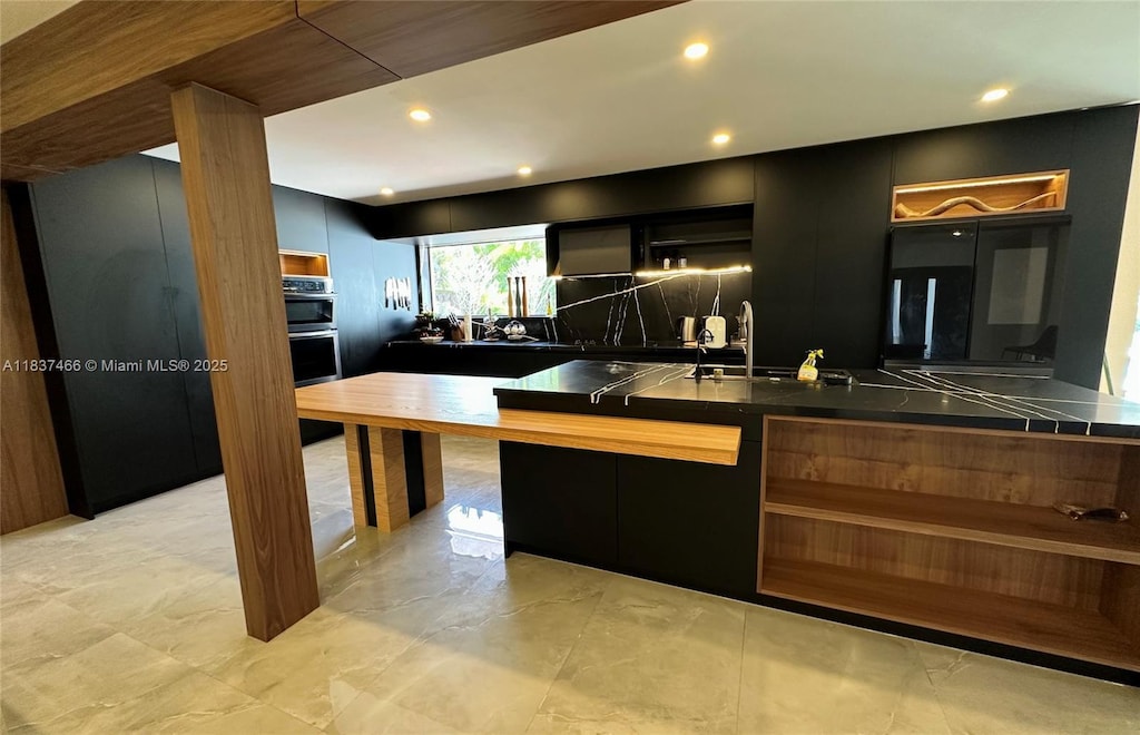 6381 Falconsgate Ave, Davie, FL 33331 - kitchen featuring open shelves, dark countertops, modern cabinets, dark cabinetry, and stainless steel double oven