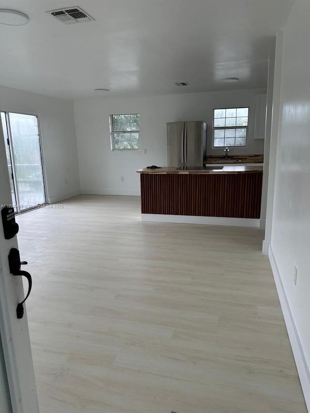 420 Burning Tree Ln, Punta Gorda, FL 33982 - kitchen featuring freestanding refrigerator, light wood-style floors, plenty of natural light, and open floor plan