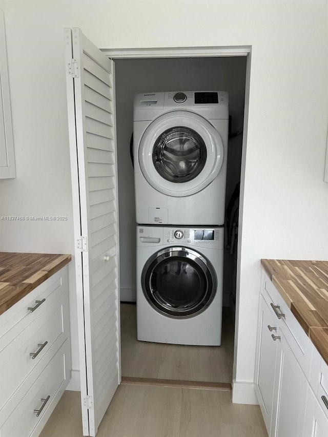 420 Burning Tree Ln, Punta Gorda, FL 33982 - washroom featuring stacked washing machine and dryer and light wood-style floors