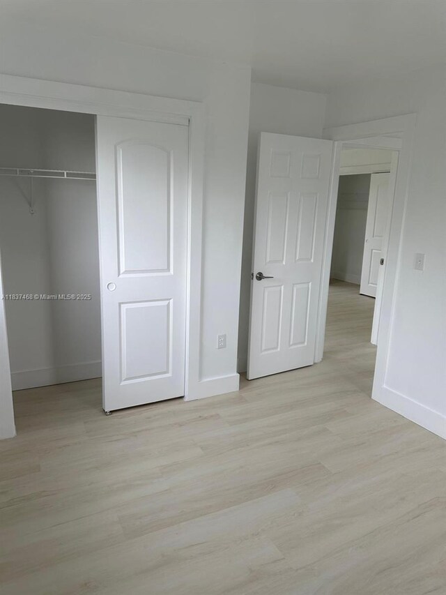 420 Burning Tree Ln, Punta Gorda, FL 33982 - unfurnished bedroom featuring light wood-style floors and a closet