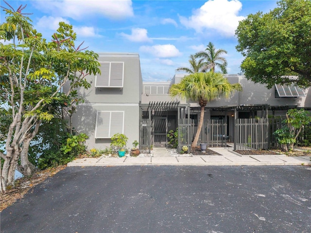 1512 NW 113th Way, Pembroke Pines, FL 33026 - townhome / multi-family property featuring a fenced front yard, stucco siding, and a gate