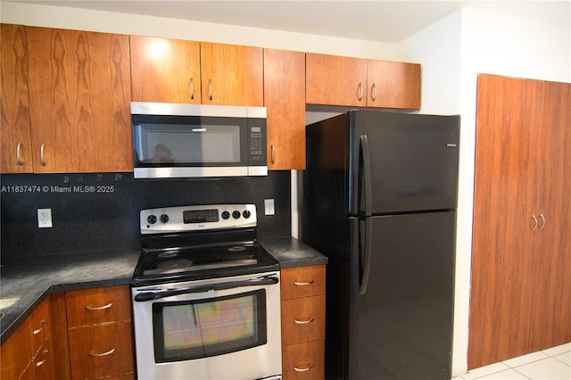 20825 NE 8th Ct Unit 203-19, Miami, FL 33179 - kitchen with appliances with stainless steel finishes, brown cabinets, and dark countertops