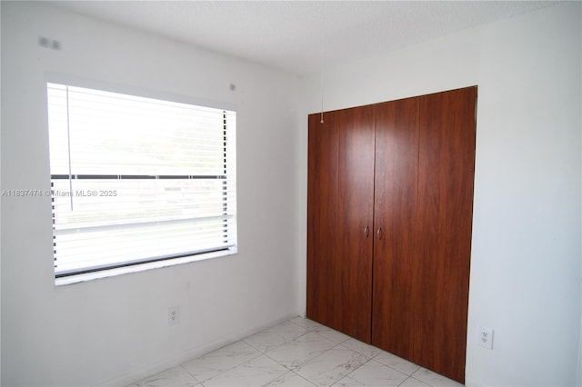 20825 NE 8th Ct Unit 203-19, Miami, FL 33179 - unfurnished bedroom featuring a closet and light marble finish floors