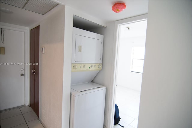 20825 NE 8th Ct Unit 203-19, Miami, FL 33179 - washroom featuring stacked washer / dryer and light tile patterned flooring