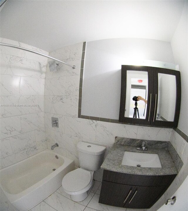 20825 NE 8th Ct Unit 203-19, Miami, FL 33179 - bathroom featuring marble finish floors, bathtub / shower combination, vanity, and tile walls