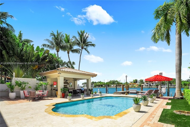 66 S Hibiscus Dr, Miami Beach, FL 33139 - swimming pool with a patio area, ceiling fan, a water view, and a boat dock