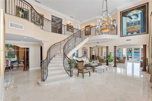 66 S Hibiscus Dr, Miami Beach, FL 33139 - living area with arched walkways, a chandelier, stairway, ornamental molding, and a towering ceiling