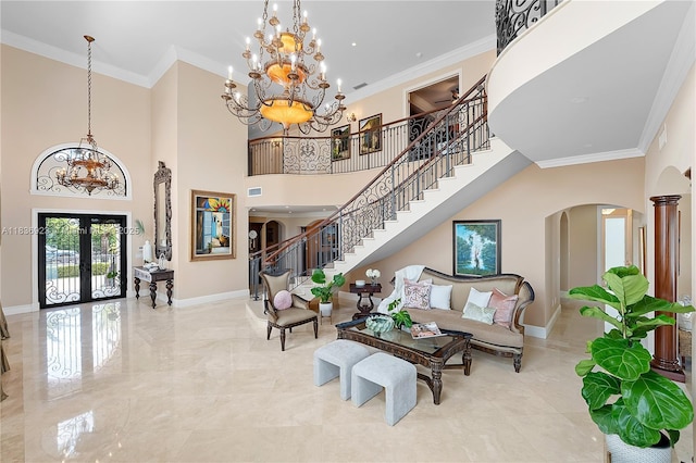 66 S Hibiscus Dr, Miami Beach, FL 33139 - entrance foyer with french doors, a chandelier, arched walkways, crown molding, and a towering ceiling