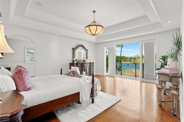 66 S Hibiscus Dr, Miami Beach, FL 33139 - bedroom featuring a tray ceiling, wood finished floors, access to outside, recessed lighting, and crown molding