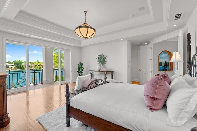 66 S Hibiscus Dr, Miami Beach, FL 33139 - bedroom with a tray ceiling, wood finished floors, a chandelier, crown molding, and recessed lighting