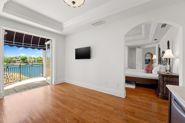 66 S Hibiscus Dr, Miami Beach, FL 33139 - indoor wet bar featuring arched walkways, a raised ceiling, light wood-style flooring, stainless steel dishwasher, and ornamental molding