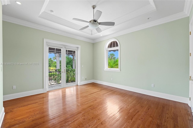 66 S Hibiscus Dr, Miami Beach, FL 33139 - unfurnished bedroom with a walk in closet, light wood-type flooring, ornamental molding, a raised ceiling, and recessed lighting