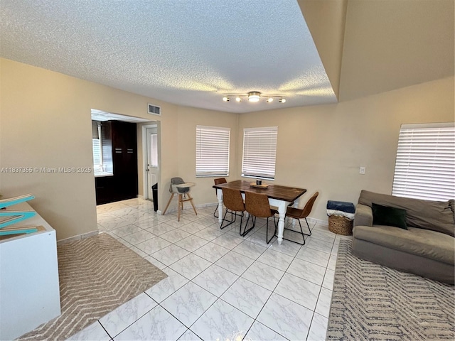11236 SW 11th St, Pembroke Pines, FL 33025 - dining room with light marble finish floors, a textured ceiling, and healthy amount of natural light