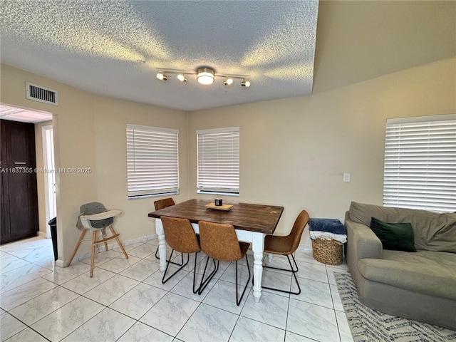 11236 SW 11th St, Pembroke Pines, FL 33025 - dining area featuring light marble finish floors, a textured ceiling, and track lighting