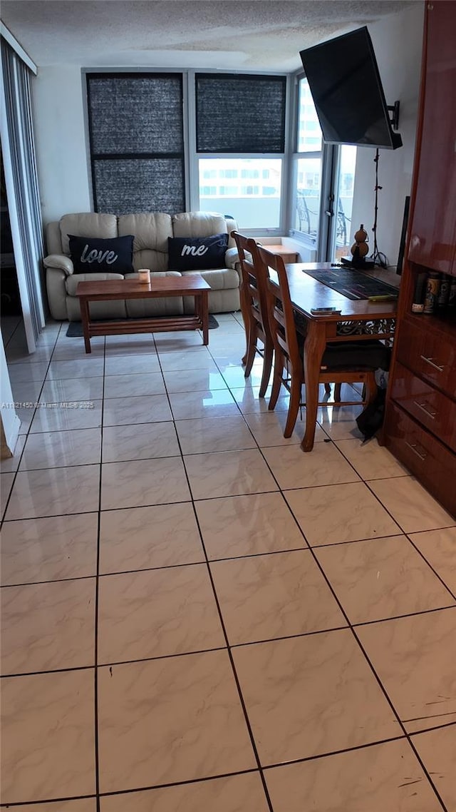 2899 Collins Ave Unit 821, Miami Beach, FL 33140 - dining area with light tile patterned floors and a textured ceiling