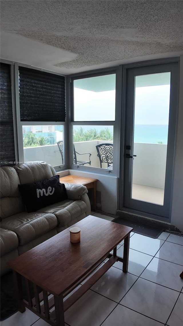 2899 Collins Ave Unit 821, Miami Beach, FL 33140 - tiled living room featuring a textured ceiling