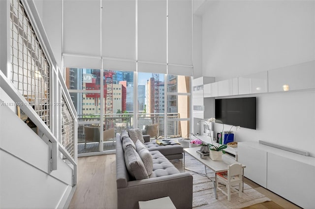 244 Biscayne Blvd Unit 446, Miami, FL 33132 - living area with wood finished floors, expansive windows, and a high ceiling
