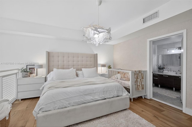244 Biscayne Blvd Unit 446, Miami, FL 33132 - bedroom featuring light wood-style flooring and ensuite bath