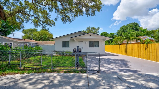 2820 NW 95th St, Miami, FL 33147 - view of front of property featuring concrete driveway, a gate, stucco siding, and a fenced front yard